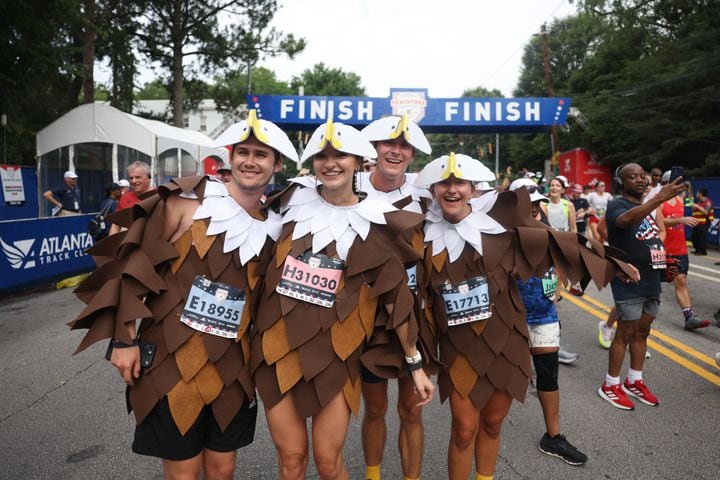 Runners dressed as bald eagles were among the costumes at the 54th Atlanta Journal-Constitution Peachtree Road Race on Tuesday, July 4, 2023.   (Jason Getz / Jason.Getz@ajc.com)