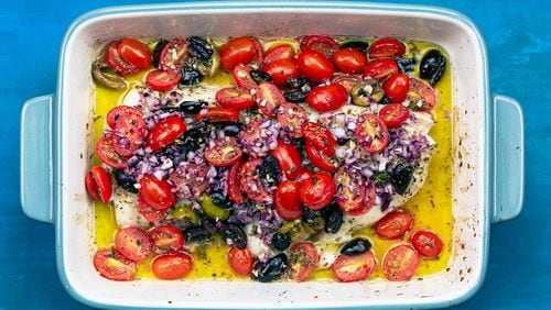 Suzy Karadsheh's baked white fish is seasoned with oregano and garlic, and topped with a mixture of tomatoes, olives and red onions. Courtesy of Suzy Karadsheh and the Mediterranean Dish