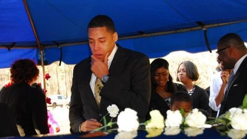 Otis Byrd Jr., grieves over his father's casket before his burial in 2014. The Rev. Otis Byrd Sr., who was fatally stabbed Jan. 5, 2014. He was 50.  CONTRIBUTED BY VINCENT BELL II