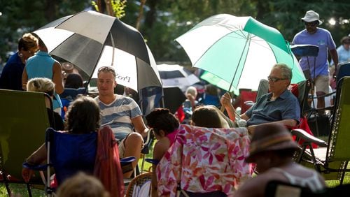 Large umbrellas are used to provide some shade before the start of the Jazz on the Lawn concert at Callanwolde Fine Art Center in Atlanta, GA Friday, July 8, 2016. People are invited to bring a picnic to enjoy during the Friday night concerts. STEVE SCHAEFER / SPECIAL TO THE AJC