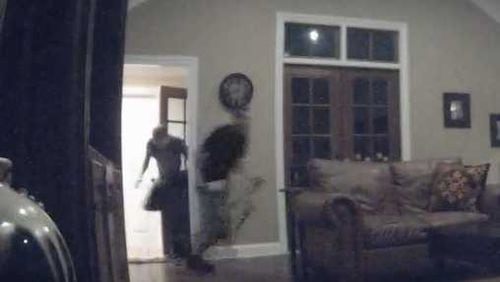 This blurry screen capture from surveillance footage shows the two suspects entering the Sandy Springs home.