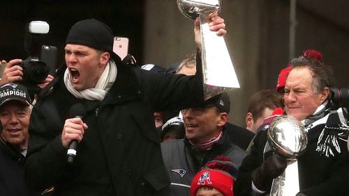 Yeah, the guy with the trophy and the microphone really needs more on his birthday. (Barry Chin /The Boston Globe via AP)