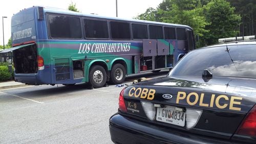 Federal authorities seized this passenger bus Thursday in Cobb County as part of an investigation into an alleged Mexico-to-Atlanta drug smuggling ring. A search of the bus revealed more than 20 kilograms of cocaine, heroin and methamphetamine in a secret compartment. Seventeen Mexican citizens have been indicted as part of the alleged alleged conspiracy, a dozen of whom have either been arrested or located in the metro area. CHRIS JOYNER/AJC