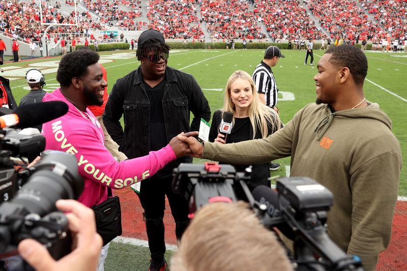041622 Athens: Former Georgia defenders from left to right; Devonte Wyatt, Jordan Davis, and Travon Walker greet each other following the National Championship ring ceremony in the G - Day game at Sanford Stadium Saturday, April 16, 2022, in Athens, Ga. (Jason Getz / Jason.Getz@ajc.com)