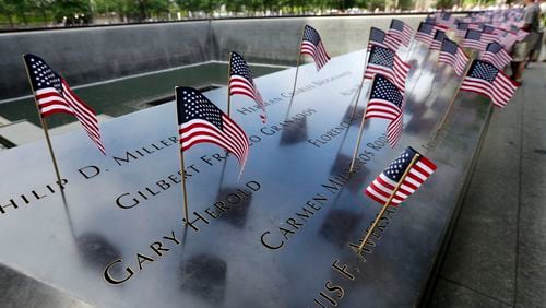 American flags were inserted in each of the 2,983 names on the 9/11 Memorial, in New York, Tuesday, July 4, 2017. (AP Photo/Richard Drew)