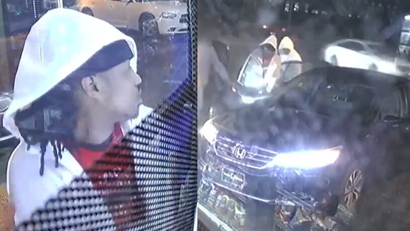 Police released surveillance video of two suspects accused of a carjacking last month.