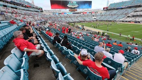 Georgia fans take their seats socially distanced style at TIAA Bank Field in Jacksonville Saturday for the annual rivalry game against Florida.