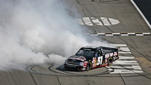 NASCAR trucks driver Kyle Busch (No. 51) burns out after winning the Easy Care 200 Saturday, Oct. 27, 2007, at Atlanta Motor Speedway in Hampton. (Pouya Dianat/AJC)
