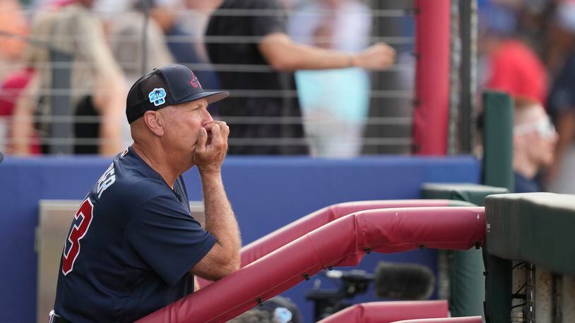 Braves manager Brian Snitker watches from the dugout in the second inning of a spring training baseball game against the Philadelphia Phillies in North Port, Fla., Saturday, March 18, 2023. (AP Photo/Gerald Herbert)