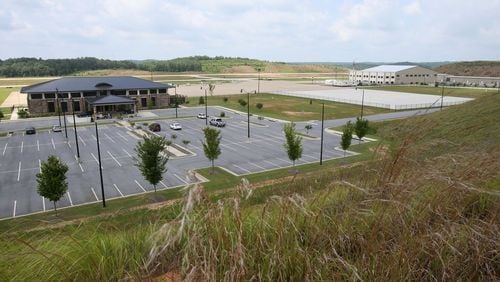 June 25, 2014 - Paulding County - The Paulding County Airport terminal (left) and new hangers (right) viewed from a hill overlooking the airport. Taxi way expansion has been completed, and construction continues in FBO area of Paulding County Airport. First, Delta CEO Richard Anderson said he would fight Paulding County’s effort to commercialize its airport. Then residents filed four legal challenges. Now, the city of Atlanta is threatening legal action, saying Paulding, which purchased land from Atlanta for the airport back in 2007, is in breach of contract on that deal. Paulding officials deny that and say Atlanta’s opposition flies in the face of the regionalism that Mayor Kasim Reed spoke about to leaders there a few years ago. BOB ANDRES / BANDRES@AJC.COM