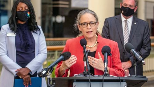 U.S. Rep. Carolyn Bourdeaux talks during a press conference flanked by Gwinnett County Commissioner Chairwoman Nicole Love Hendrickson (L) and County Community Improvement District Director Joe Allen (R) at the Gwinnett Place Mall in Duluth STEVE SCHAEFER FOR THE ATLANTA JOURNAL-CONSTITUTION