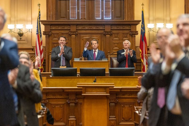 Gov. Brian Kemp salutes legislators during the State of the State speech he gave Wednesday at the Capitol in Atlanta. (Arvin Temkar / arvin.temkar@ajc.com)