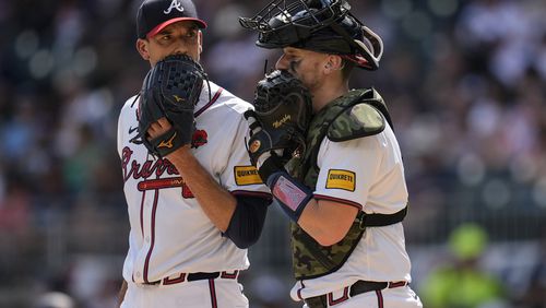 Atlanta Braves pitcher Charlie Morton, left, and catcher Sean Murphy speak on the mound in the first inning of a baseball game against the Washington Nationals, Monday, May 27, 2024, in Atlanta. (AP Photo/Mike Stewart)
