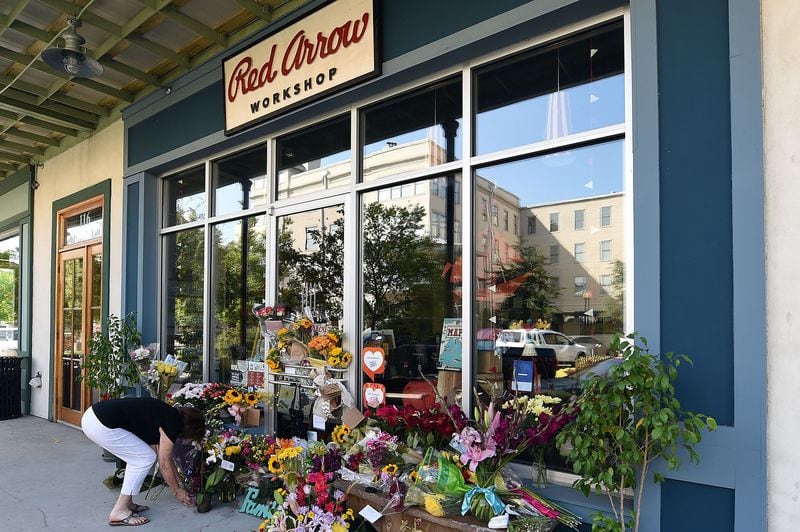 LAFAYETTE, LA - JULY 25: Mourners leave flowers at a makeshift memorial outside of a store owned by one of the two people John Russell Houser killed at a Louisiana movie theater before shooting himself.