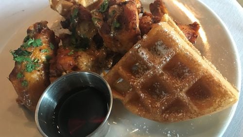 Start a meal at Urban Foodie Feed Store with an order of Dylan’s Chicken & Waffles that brings a half dozen wings swathed in a lime-pepper wing sauce and swiped with ancho-chile ranch plus chile-bacon waffle segments and syrup. LIGAYA FIGUERAS / LFIGUERAS@AJC.COM