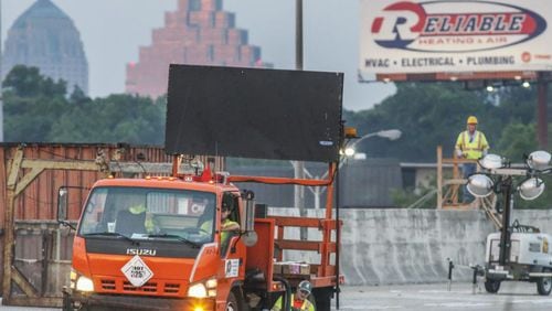 Construction crews were seen installing road reflectors on Friday morning May 12, 2017 as last-minute preparations for the reopening of I-85 in Atlanta continued. JOHN SPINK/JSPINK@AJC.COM