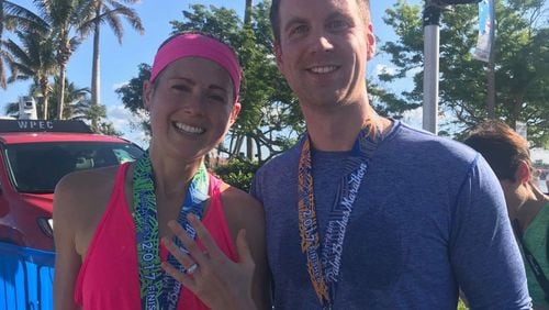 Jamie Sheahan shows off the engagement ring she got from fiance Brendan Smith-Heafy at the end of the Fitteam Palm Beaches Marathon on Sunday.