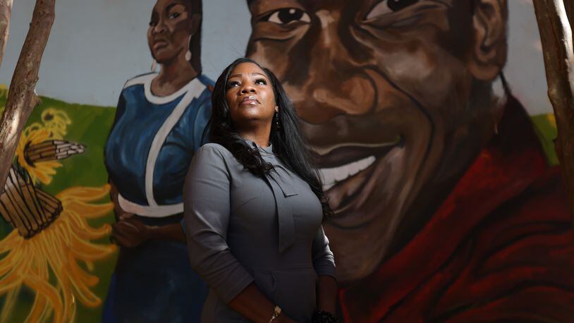 Monteria Robinson, the mother of Jamarion Robinson, poses in front of a mural dedicated to her son’s memory. The mural is located in downtown Atlanta. Ms. Robinson was relieved to see charges brought against the officers that who shot her son five years ago. Wednesday, November 10, 2021. Miguel Martinez for The Atlanta Journal-Constitution 