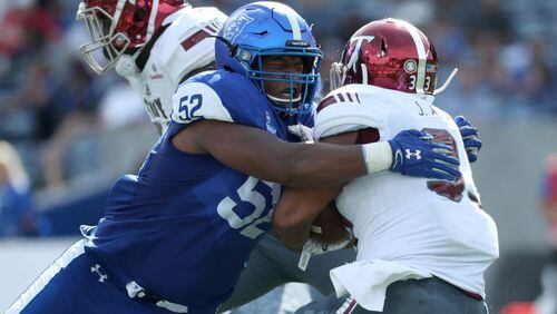October 21, 2017 - Atlanta, Ga: Georgia State Panthers defensive lineman Dontae Wilson (52) tackles Troy Trojans running back Josh Anderson (33) for a short gain in the second quarter of their game at GSU Stadium Saturday, October 21, 2017, in Atlanta.. PHOTO / JASON GETZ