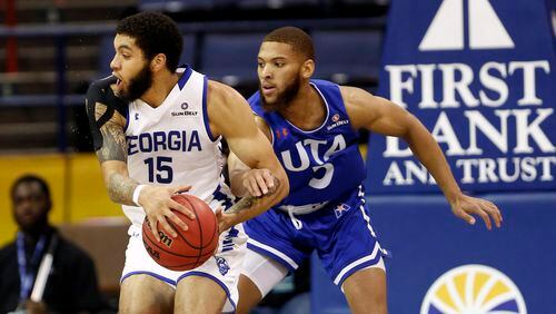 Georgia State guard D'Marcus Simonds (23) is defended by Texas-Arlington guard Edric Dennis (5) during the first half of the Sun Belt Conference men's tournament final Sunday, March 17, 2019, in New Orleans.