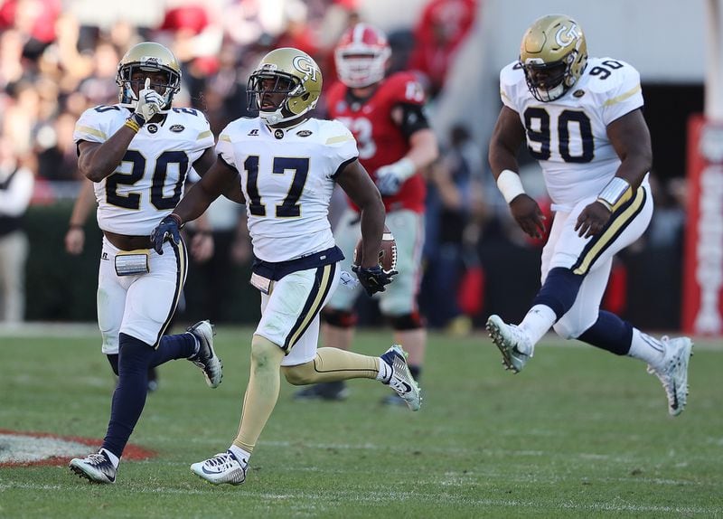 Georgia Tech defenisve tackle Brandon Adams (90) celebrated a critical Yellow Jackets interception by Lance Austin (17) in Tech’s win over Georgia in 2016 in Athens. 