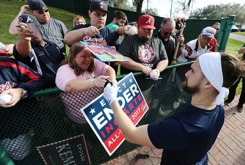 Braves outfielder Ender Inciarte cools down from a morning batting practice by signing a few autographs on the way back to the clubhouse.  (Curtis Compton/ccompton@ajc.com)
