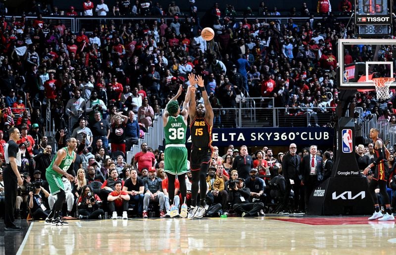 Boston Celtics' guard Marcus Smart (36) shoots over Atlanta Hawks' center Clint Capela (15). (Hyosub Shin / Hyosub.Shin@ajc.com)