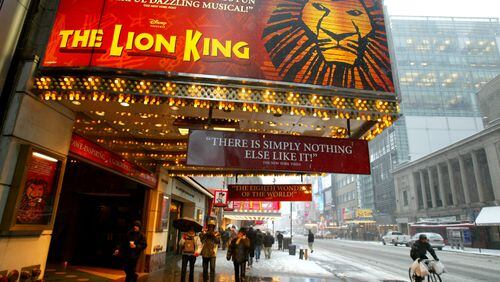 NEW YORK - MARCH 6: Pedestrians walk beneath a sign for the musical 'The Lion King' March 6, 2003 in New York City. The 1994 animated Disney film, which grossed $968.8 million, has been successful as a musical for 19 years and will be made into a live-action movie, according to The Walt Disney Company. (Photo by Mario Tama/Getty Images)