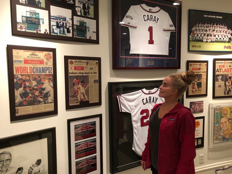 Skip Caray’s widow, Paula Caray, in the basement of her Atlanta home, flanked by memories of 1995 and other seasons. (Photo by Steve Hummer)