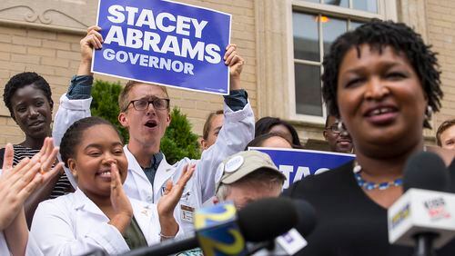 09/10/2018 -- Atlanta, Georgia -- Medical students cheer as Georgia Democratic Gubernatorial candidate Stacey Abrams is introduced to speak about her healthcare plan for Georgia outside of Grady Memorial Hospital in Atlanta, Monday, September 10, 2018. (ALYSSA POINTER/ALYSSA.POINTER@AJC.COM)