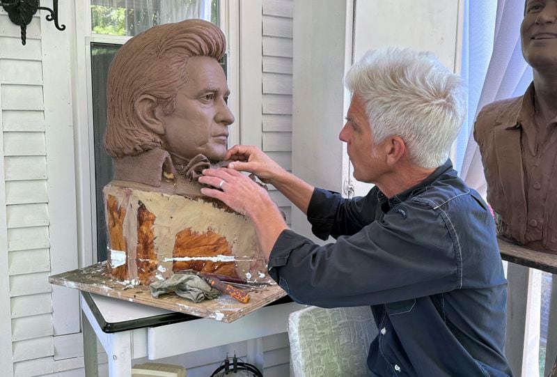 Artist Kevin Kresse, works on a clay bust of Johnny Cash, April 23, 2024 in Little Rock, Ark. Kresse's full sculpture of Cash will be unveiled at the U.S. Capitol as part of the Statuary Hall collection, later this year. (AP Photo/Mike Pesoli)