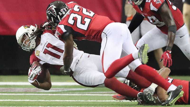 Falcons safety Keanu Neal levels Cardinals wide receiver Larry Fitzgerald with a hard hit during the fourth quarter and is called for a personal foul on the play Sunday, Nov. 27, 2016, in Atlanta. The Falcons beat the Cardinals 38-19.