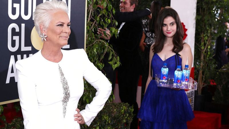 Kelleth Cuthbert is seen standing behind Jamie Lee Curtis at the 76th annual Golden Globe® Awards, Sunday, Jan. 6, 2019 in Beverly Hills, Calif. Cuthbert is now suing Fiji Water.