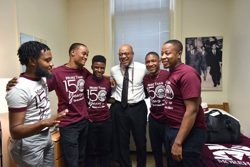 Morehouse President David A. Thomas shares a laugh with Wendell Shelby-Wallace (left), then vice president of the Student Government Association, Marcus Washington, MarKuan Tigney Jr., David Jeffries and Kayden Molock after he moved into his room at historic Graves Hall in Morehouse College in 2018. Thomas temporarily lived in the hall to learn more about student life and college affordability. (Hyosub Shin / AJC file photo)
