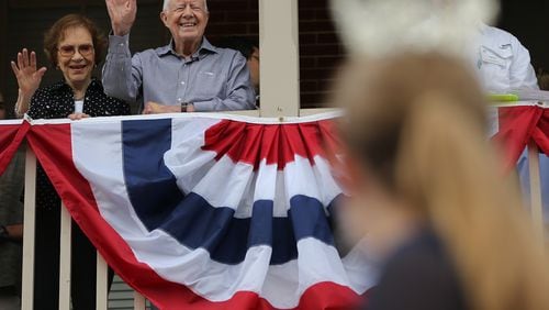 Former President Jimmy Carter and First Lady Rosalynn Carter wave to a beauty queen during the Peanut Festival on Saturday September 26, 2015 in Plains. The consensus among Plains residents was that it was the largest crowd ever for the festival. Ben Gray / bgray@ajc.com
