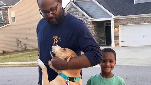 Recent clients of Paws Between Homes are reunited with their dog Ruby. The nonprofit provides free shelter for pets of families experiencing a housing crisis. Courtesy of Paws Between Homes