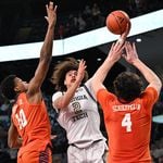 Nait George shoots against a pair of Clemson defenders during Wednesday's game at McCamish Pavilion. The Yellow Jackets were defeated by the Tigers 81-57.