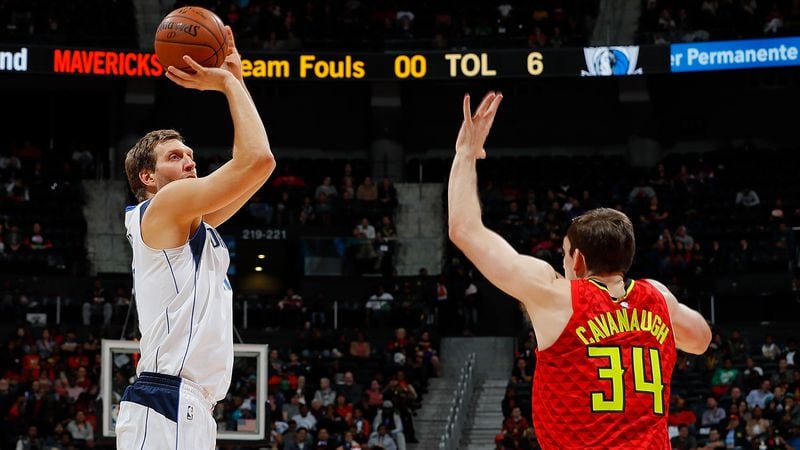  Dirk Nowitzki of the Dallas Mavericks attempts a shot against Tyler Cavanaugh  of the Atlanta Hawks at Philips Arena on December 23, 2017 in Atlanta, Georgia.   (Photo by Kevin C. Cox/Getty Images)