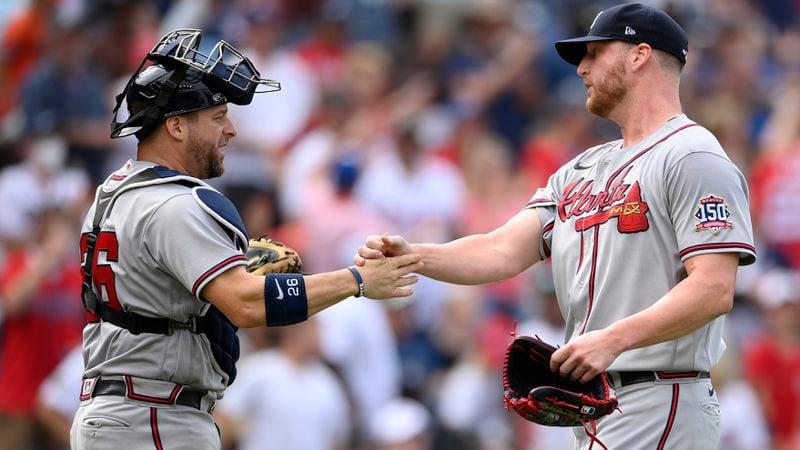 Braves reliever Will Smith (right) celebrates with catcher Stephen Vogt after 6-5 win over the Washington Nationals, Sunday, Aug. 15, 2021, in Washington. (Nick Wass/AP)