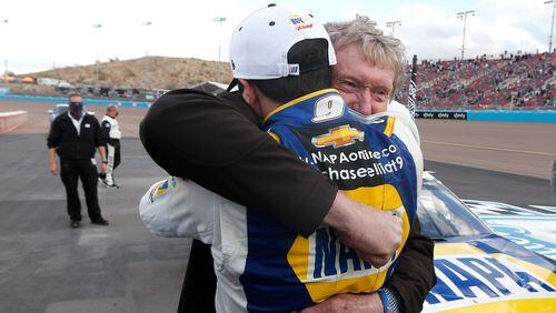 Chase Elliott hugs his father Bill Elliott after winning the season championship during a NASCAR Cup Series race Sunday, Nov. 8, 2020, at Phoenix Raceway in Avondale, Ariz. Bill is also a former series champion. (Ralph Freso/AP)