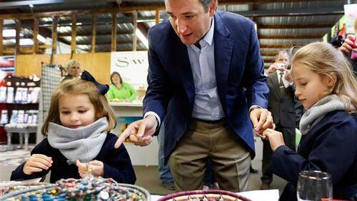 Republican presidential candidate Sen. Ted Cruz and daughters Catherine, left, and Caroline during a campaign stop. AP photo: Jim Cole