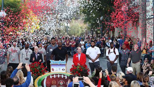 Confetti flies over Georgia and Oklahoma coaches and players at Disney California Adventure Park on Wednesday.