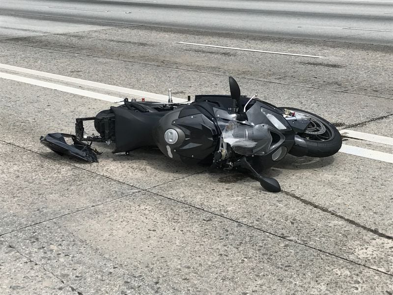 A motorcycle crashed when a portion of I-20 West buckled Monday morning. ERIC STIRGUS / ERIC.STIRGUS@AJC.COM