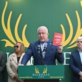 Bill White, chairman and CEO of the Buckhead City Committee, holds a book titled "Never Give Up" as he begins speaking to members of the press during a news conference to discuss an important series of next steps outside the Buckhead City Committee headquarters on Tuesday, February 18, 2022. (Hyosub Shin / Hyosub.Shin@ajc.com)