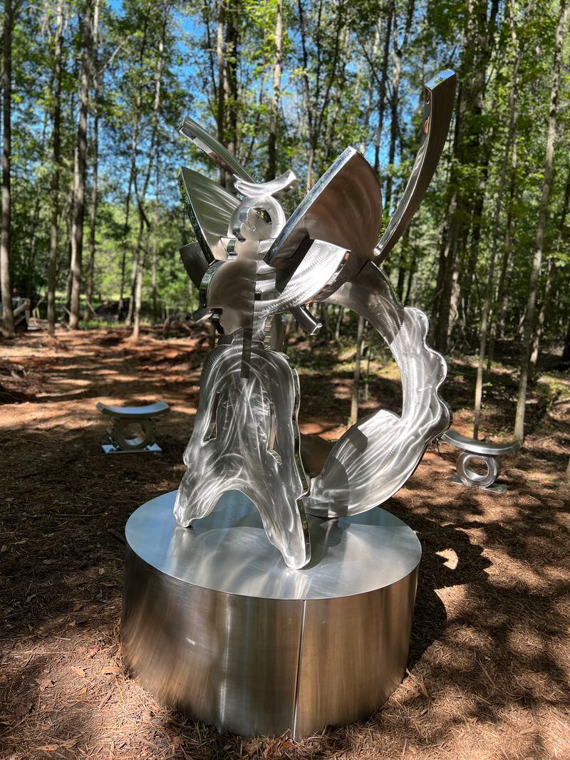 Patterson’s sculpture is encircled by a series of small stools with tall trees beyond. (Photo by Hannah Brandes)