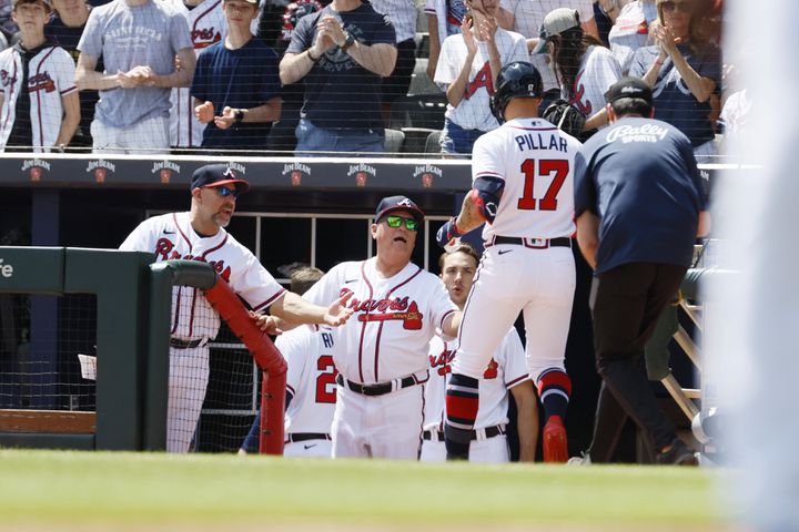 Braves left fielder Kevin Pillar is congratulated by manager Brian Snitker (43)  as he walks to the dugout after hitting a solo home run during the fifth inning against the Houston Astros at Truist Park, Sunday, April 23, 2023, in Atlanta. 
 Miguel Martinez / miguel.martinezjimenez@ajc.com 