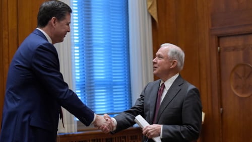 WASHINGTON, DC - FEBRUARY 9:  Attorney General Jeff Sessions, right, shares hands with FBI Director James Comey, left, at the start of a meeting with the heads of federal law enforcement components at the Department of Justice  February 9, 2017 in Washington, DC. A report from The New York Times claims Comey asked Sessions not to let him be alone with President Donald Trump after Trump asked him about the investigation into former national security adviser Michael Flynn. (Photo by Susan Walsh-Pool/Getty Images)