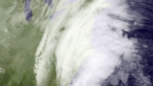 This satellite image taken around 12:12 a.m. EDT and released by the National Oceanic and Atmospheric Administration, shows clouds around the Northeast of the United States, Tuesday, March 14, 2017. A powerful nor'easter could bring blizzard conditions and more than a foot of snow from the mid-Atlantic to parts of the Northeast, and officials warn of potential beach erosion, possible coastal flooding and power outages from the late-season snowstorm. (NOAA via AP)