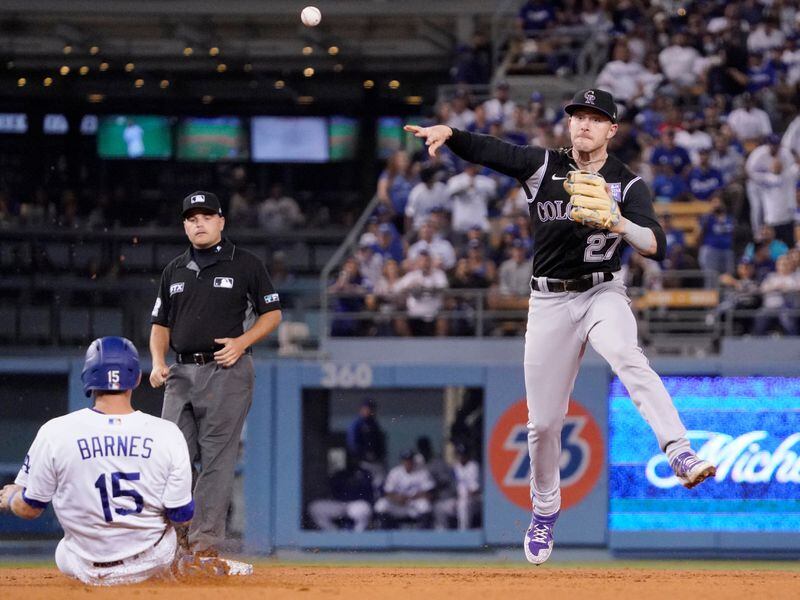 Los Angeles Dodgers' Austin Barnes (left) is forced out at second as Colorado Rockies shortstop Trevor Story throws out Sheldon Neuse at first during the seventh inning Saturday, July 24, 2021, in Los Angeles. (Mark J. Terrill/AP)