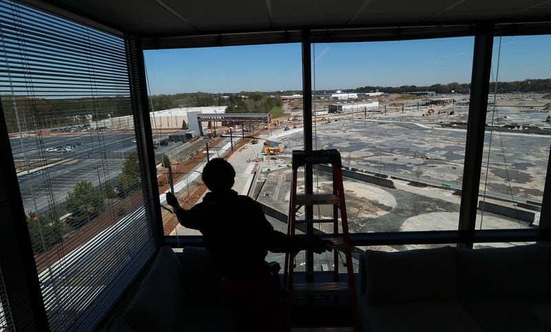 Orien Reid installs window blinds at the new Serta Simons Bedding headquarters overlooking the Assembly development in Doraville.